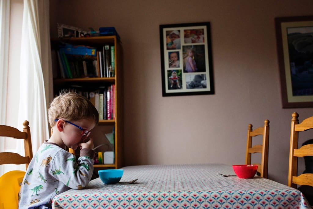 boy eating breakfast alone
