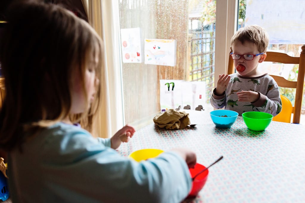 boy eating giant strawberry during London family photography session
