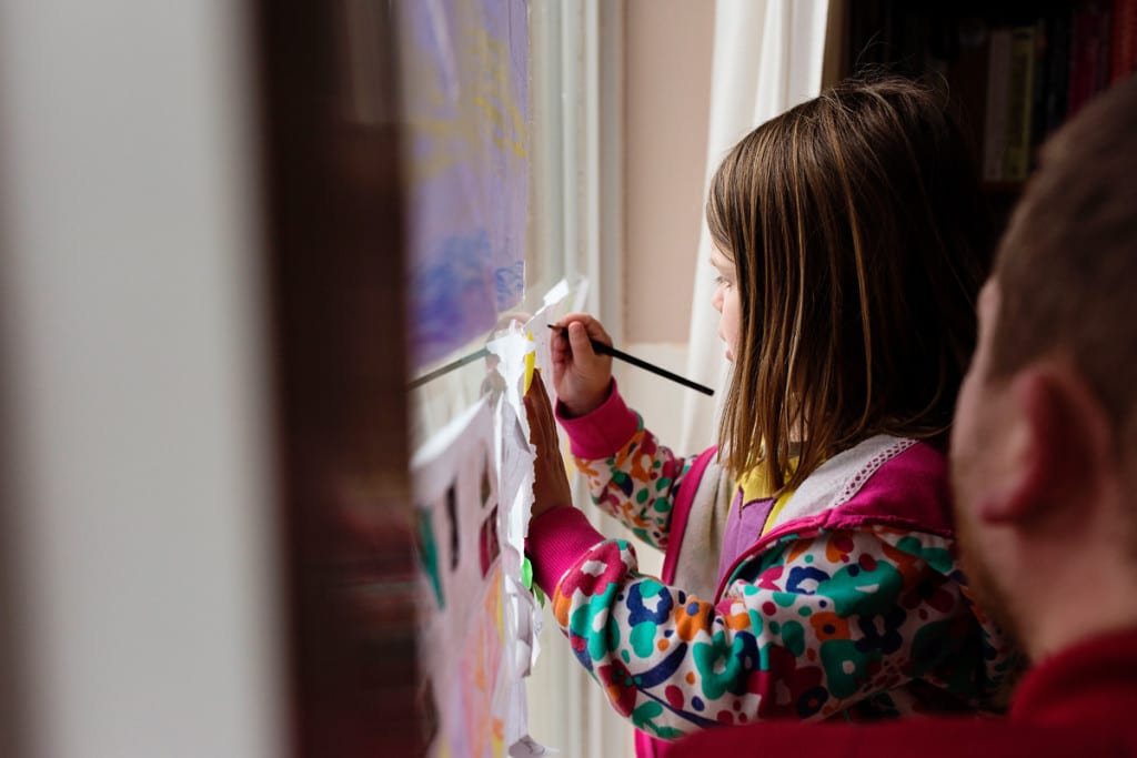 girl drawing in window