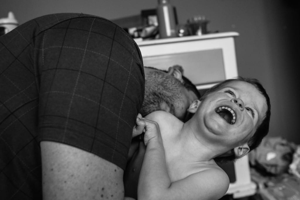 Dad tickling son during London family photography session