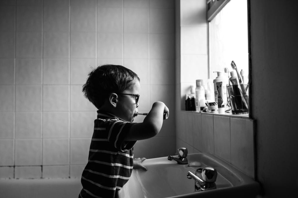 boy brushing teeth during London family photography session