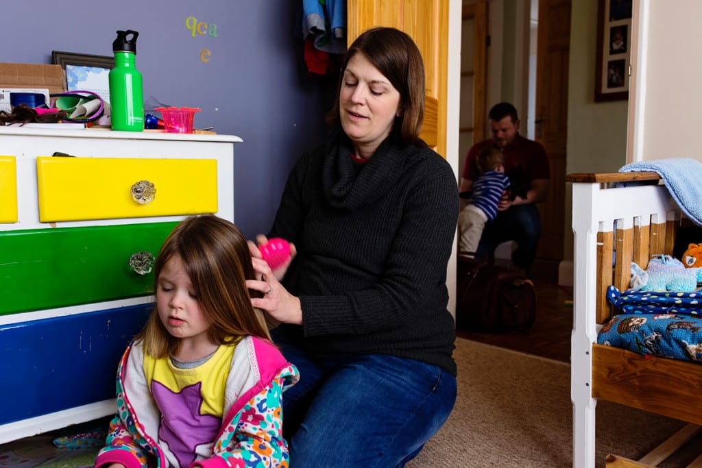 parents helping children get ready during London family photography session