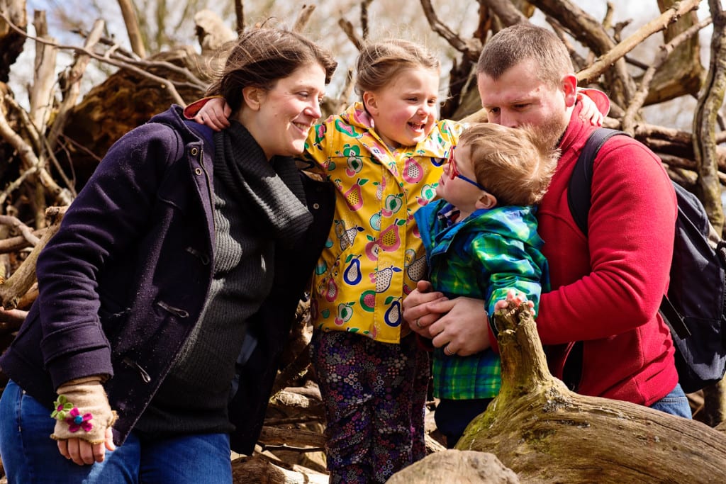 Family playing on logs during London family photography session