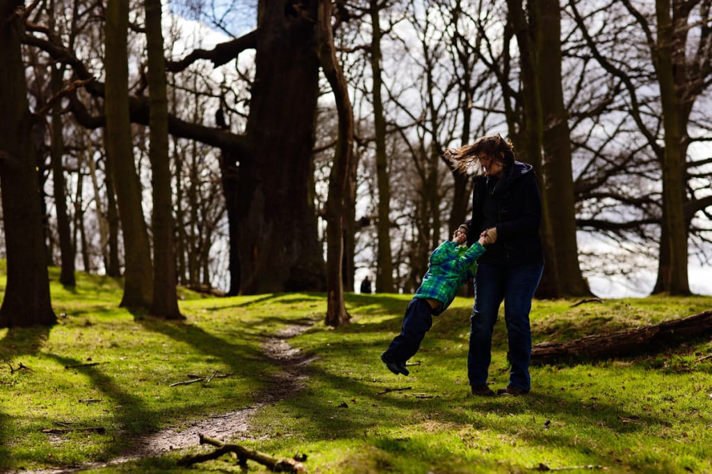 Mom swinging son during London family photography session
