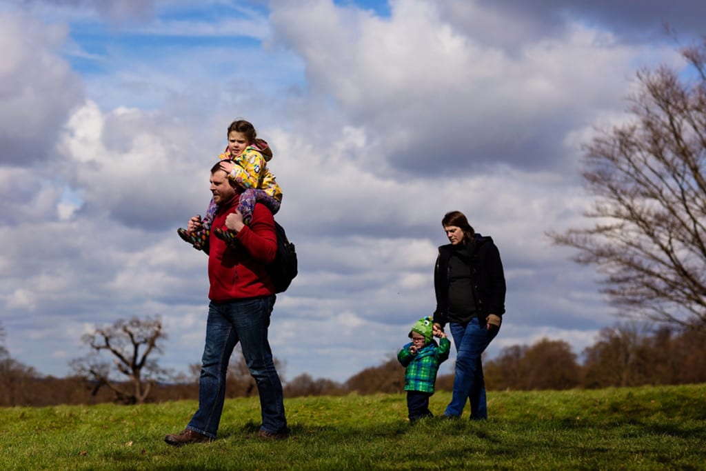 Family walking through Richmond Park during London family photography session