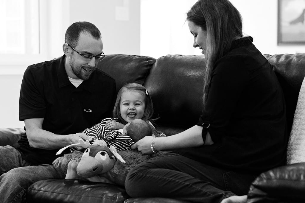 sister squealing about holding brother during family portrait session