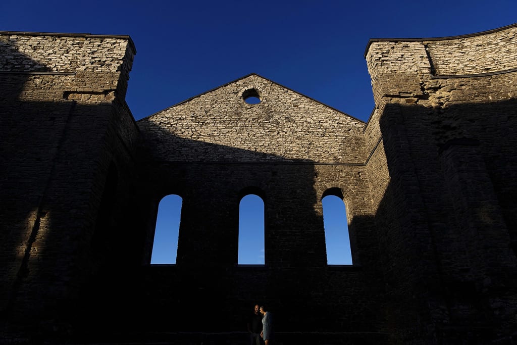Couple in spotlight at bottom of main church wall during St Raphael's engagement session