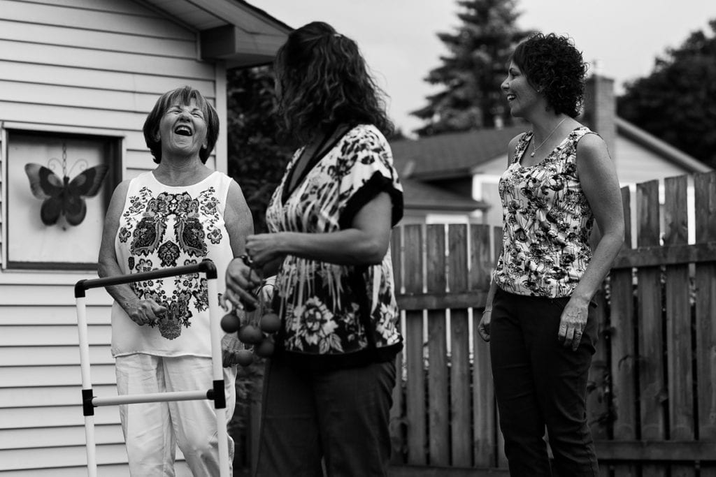 mom and daughters in floral shirts playing summer games