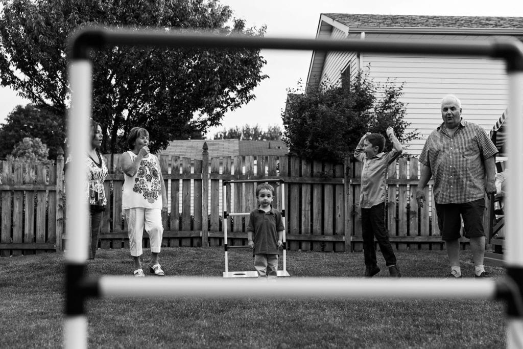 kids playing summer yard games with grandparents