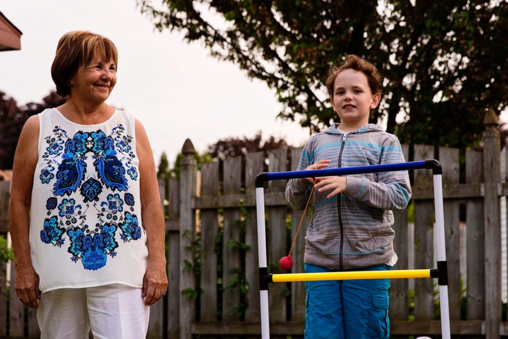 boy playing summer yard games with grandma