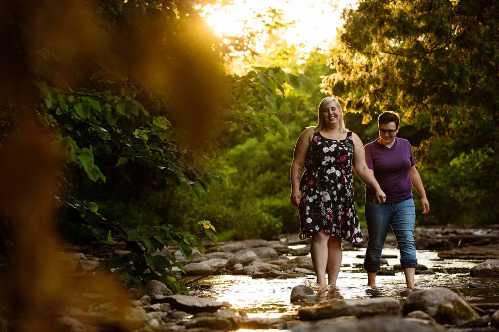 Women walking through rocky riverbed