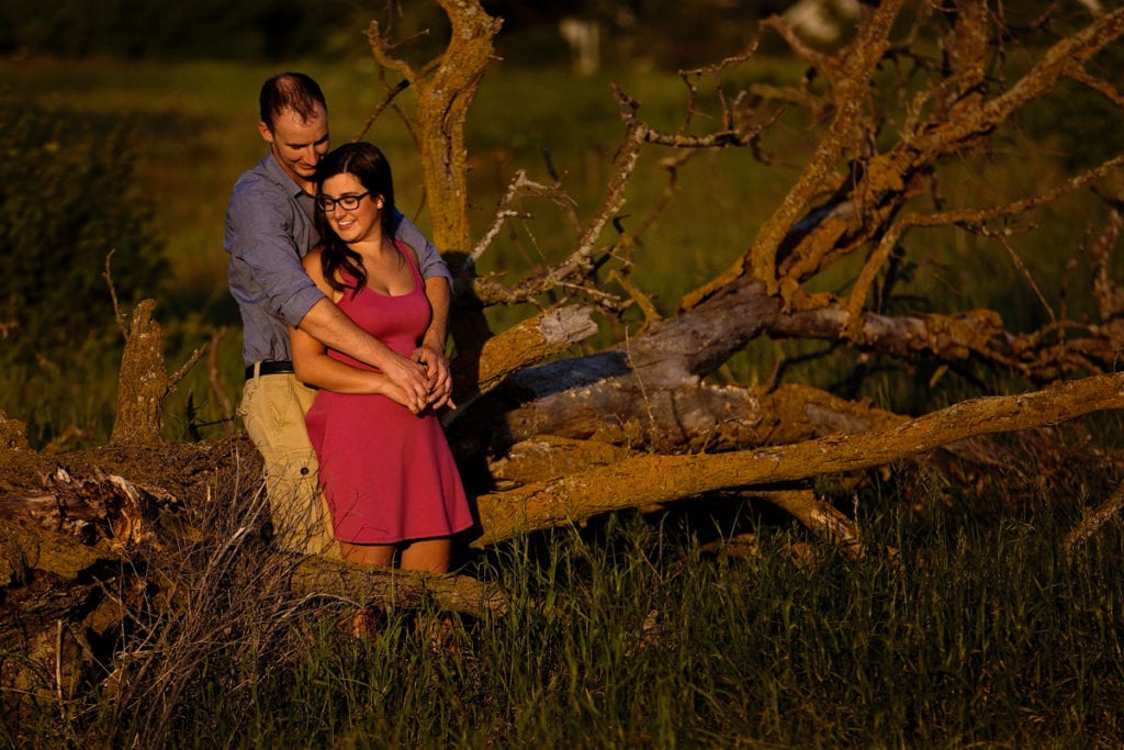 Couple leaning on old tree in Rural Ontario Engagement session