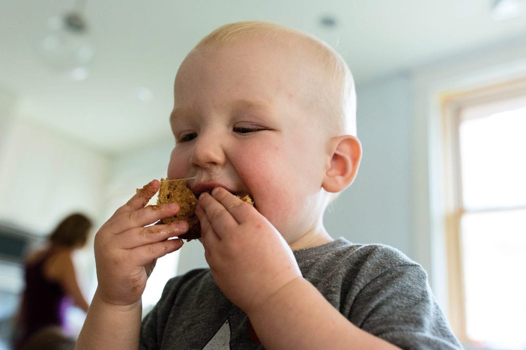 Snotty baby eating a sandwich