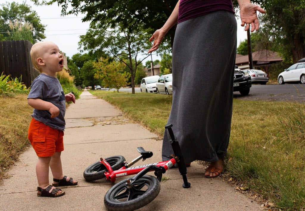 Baby and bike on sidewalk with mom