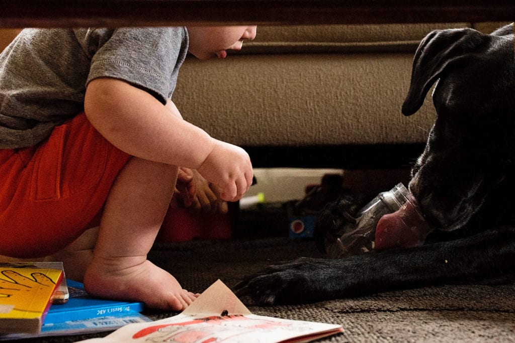 Baby squatting with coloring book