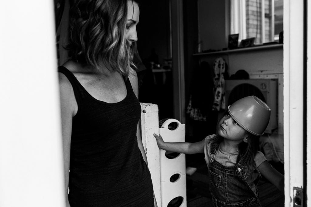 Mom and daughter with bowl on her head