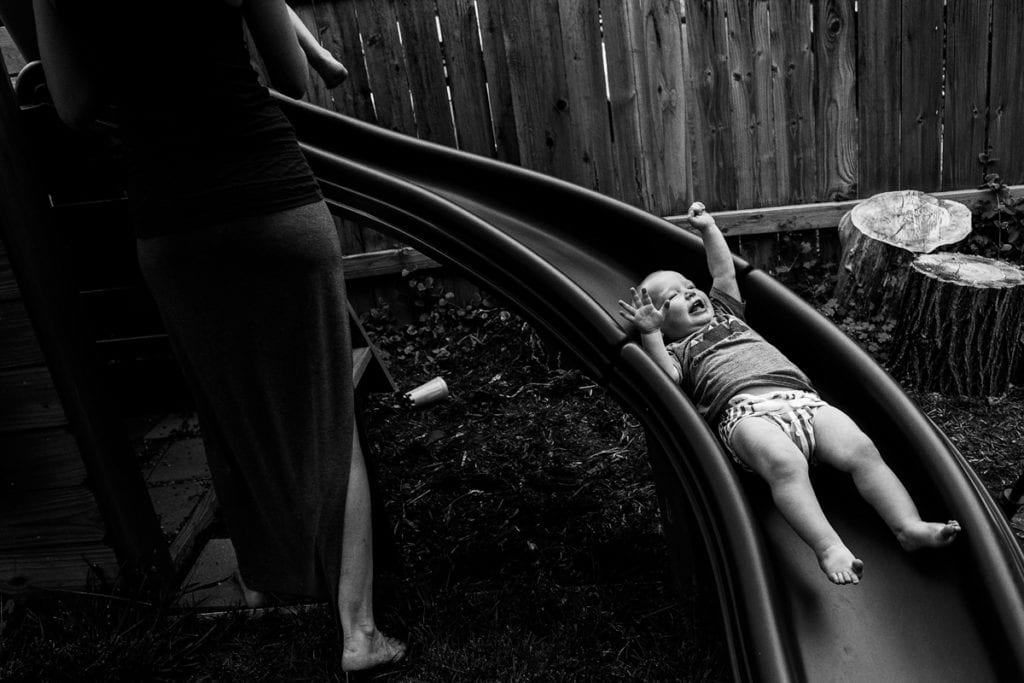 Baby on backyard slide