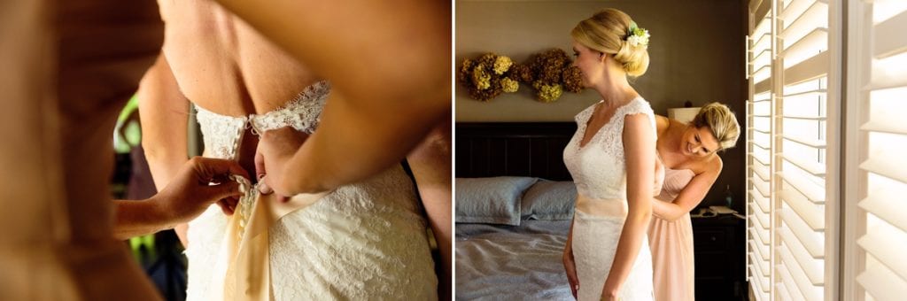 Bride in full lace wedding dress getting ready with bridesmaid