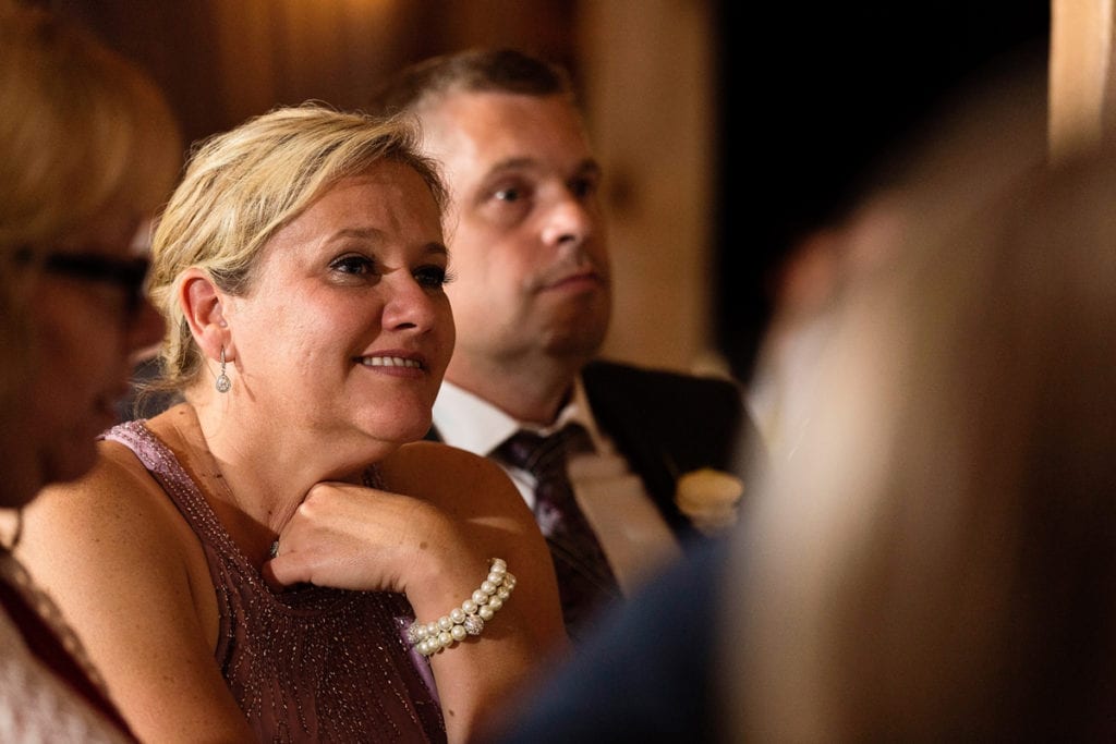 Mother and father of the bride looking on during wedding ceremony