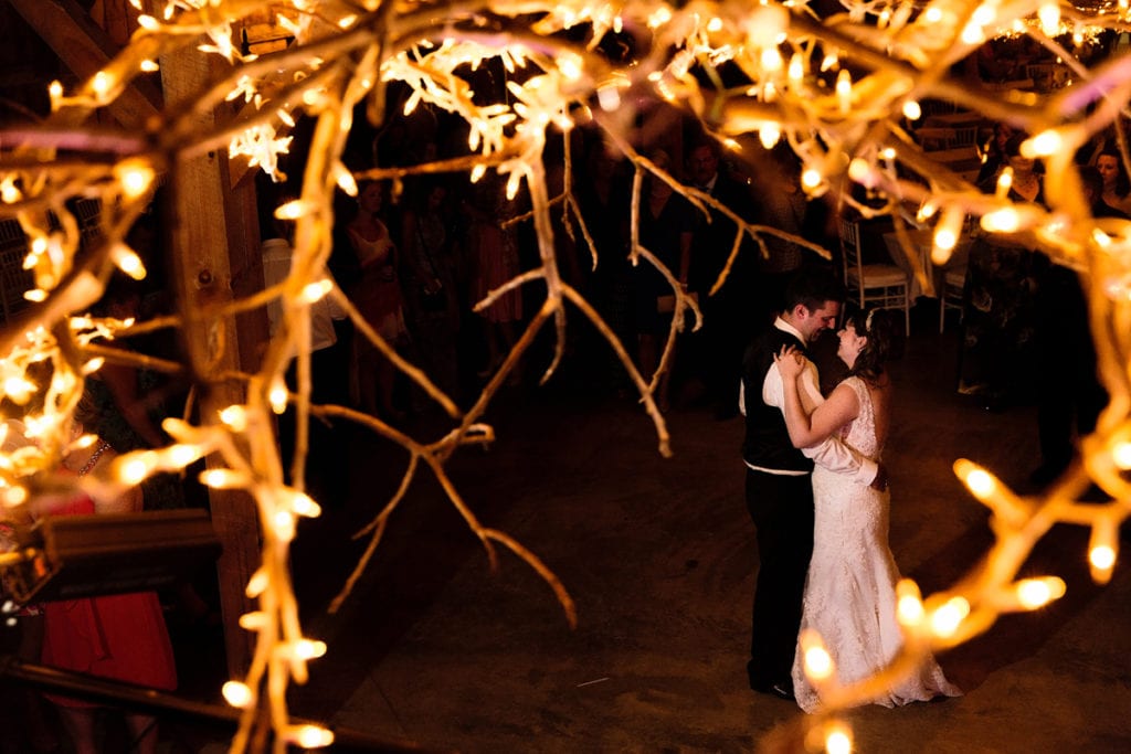 Rustic twine lighting and first dance at fairgrounds venue