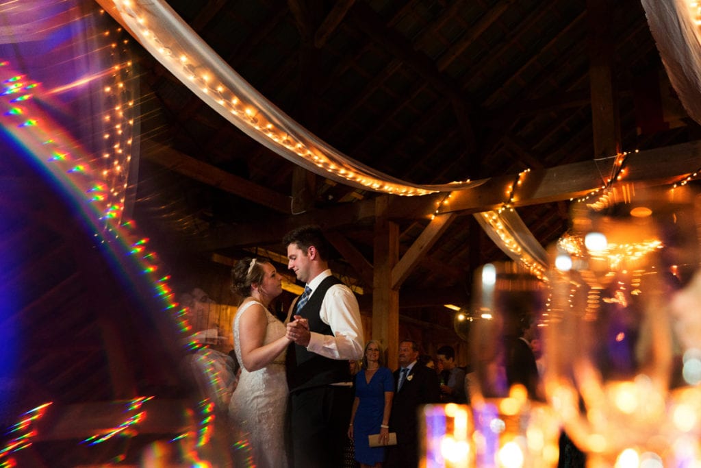 Bride and groom first dance in rustic barn reception venue