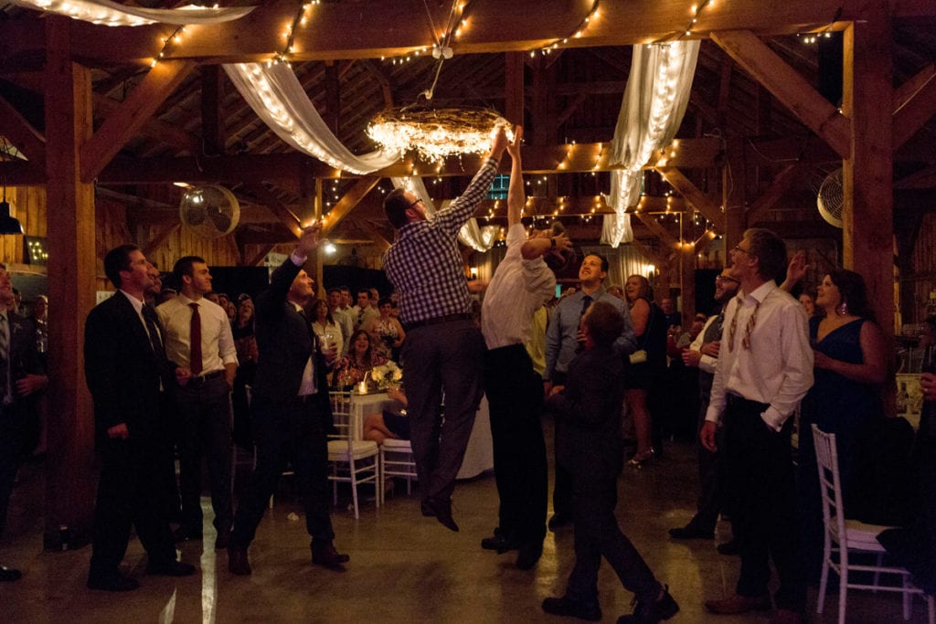 Garter toss scramble in barn reception venue