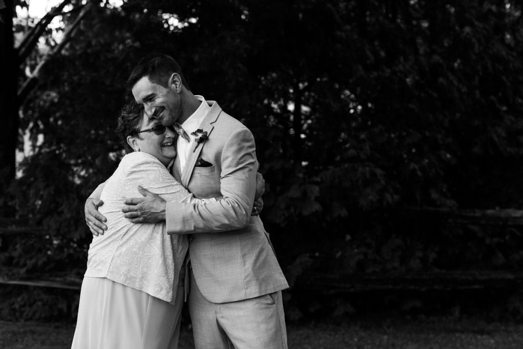 Groom hugging mother at intimate Strathmere wedding