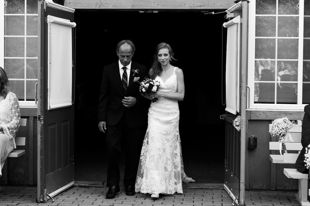 Bride being escorted by her father down the aisle