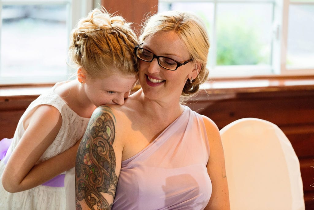 Flower girl and bridesmaid in blush dress at head table