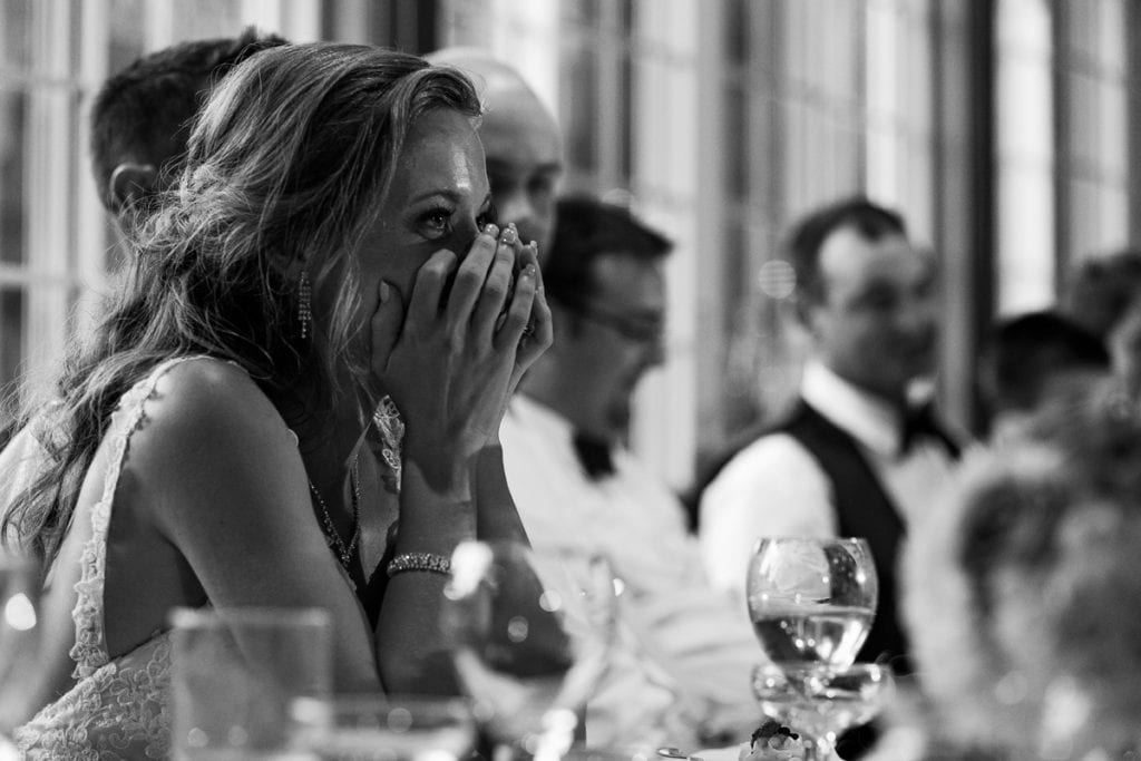 Bride at head table laughing during speeches at intimate Strathmere wedding