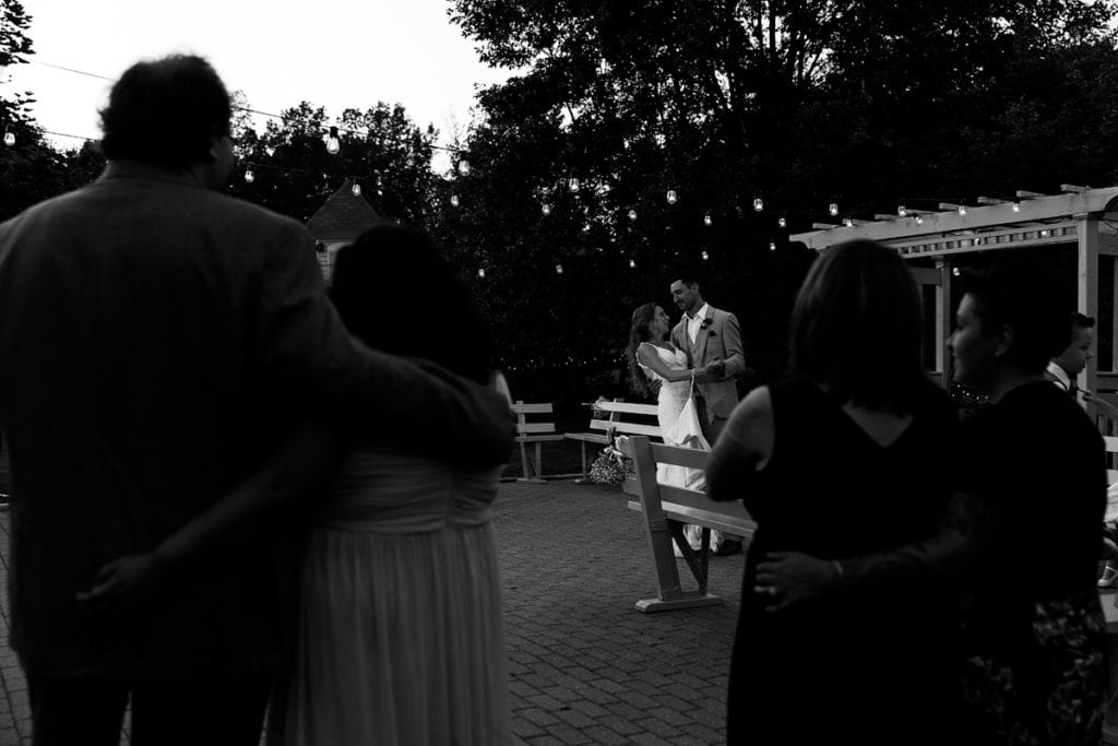 Bride and groom's first dance on outdoor patio at intimate Strathmere wedding