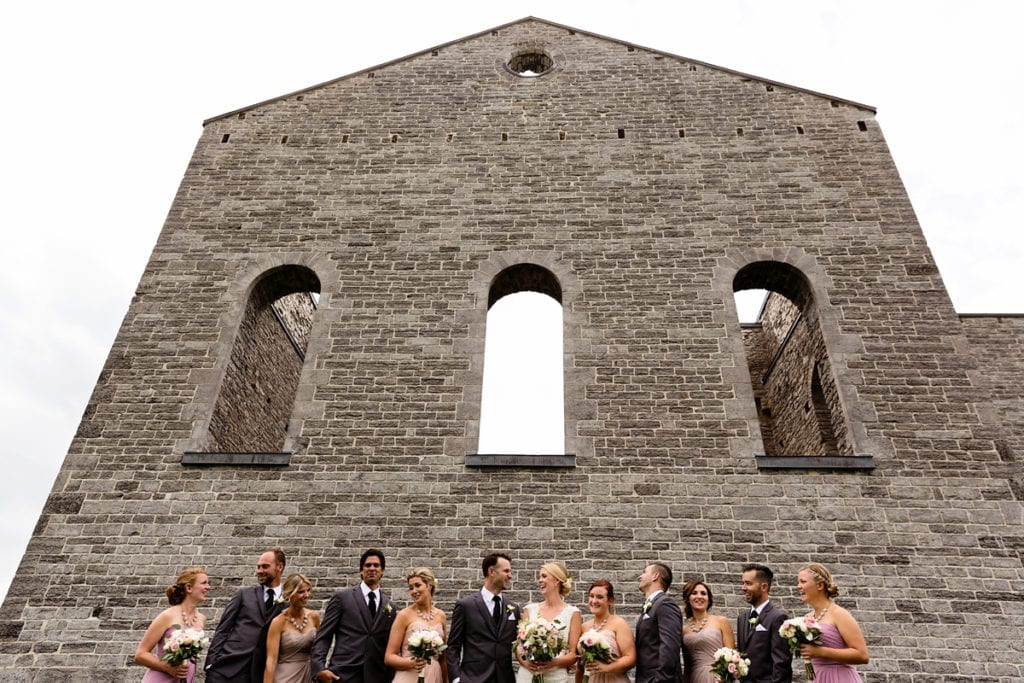 Wedding party group shot against church ruins in rural ontario wedding