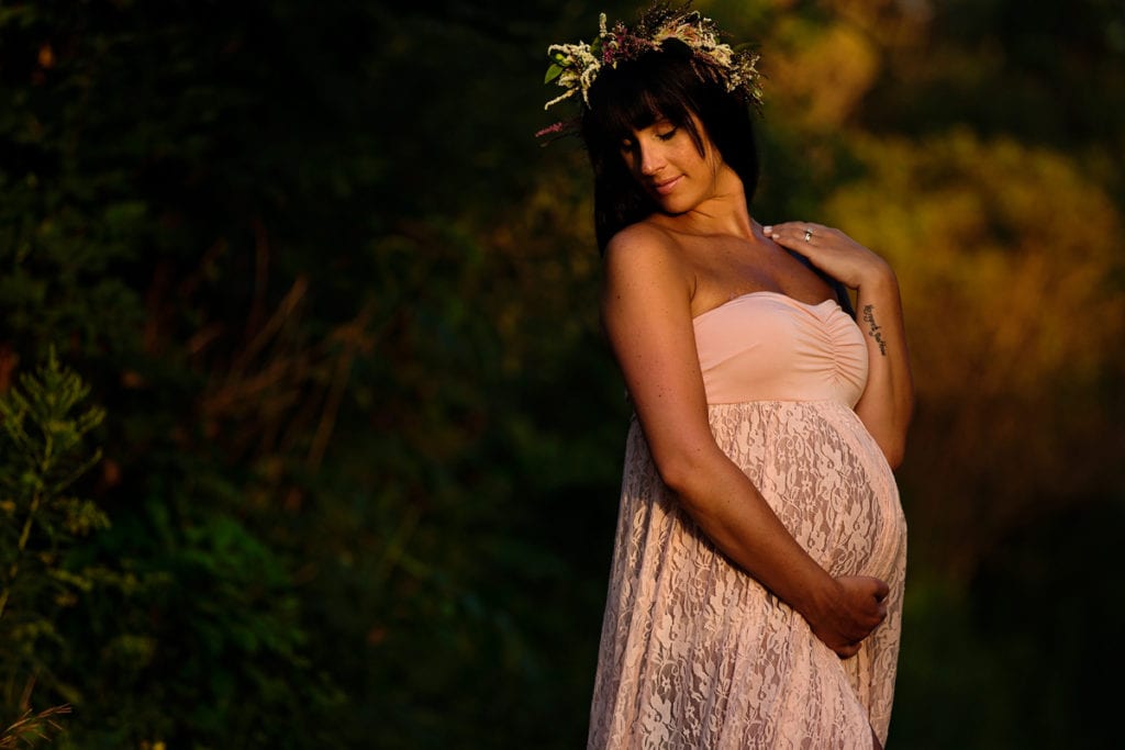 Bohemian mom in floral crown sunset maternity shoot
