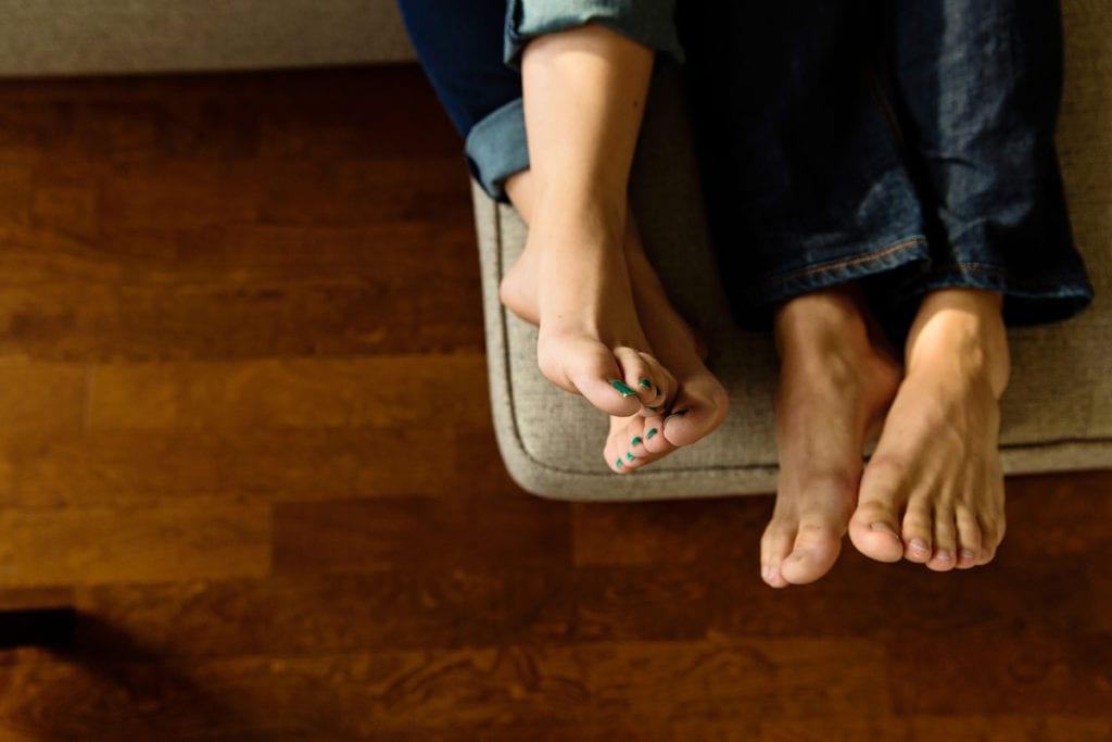 Couple resting feet on ottoman in urban Cornwall loft condo