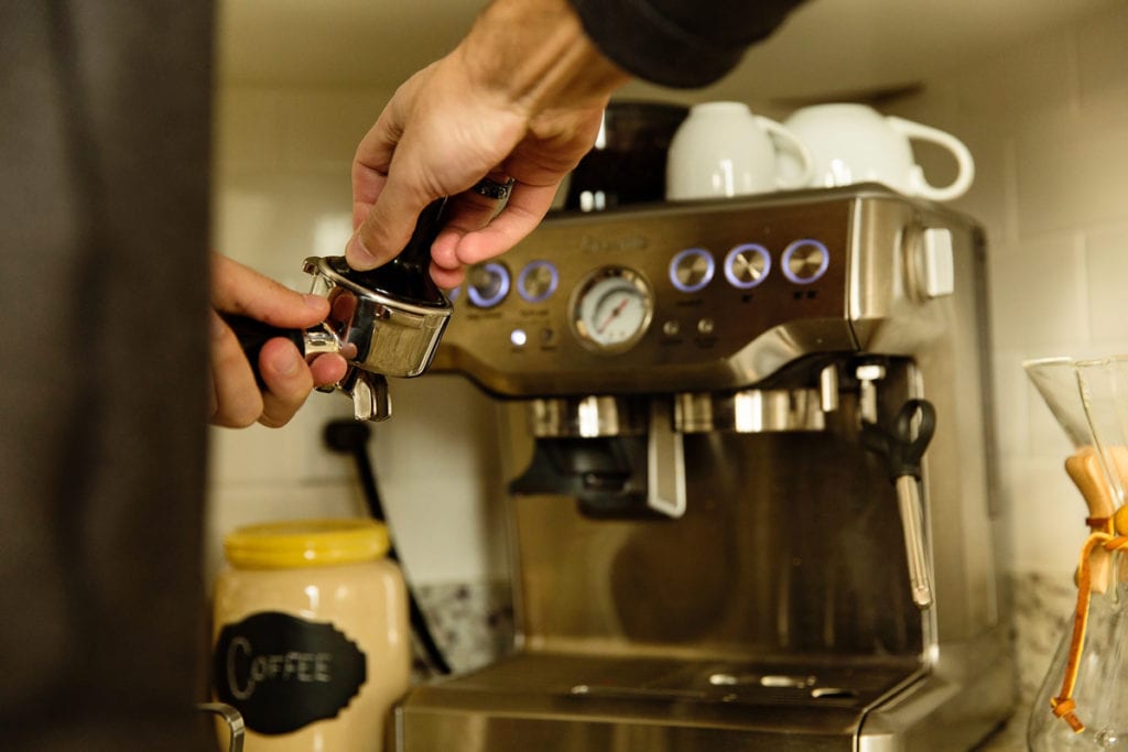 Man making coffee in modern Cornwall loft condo