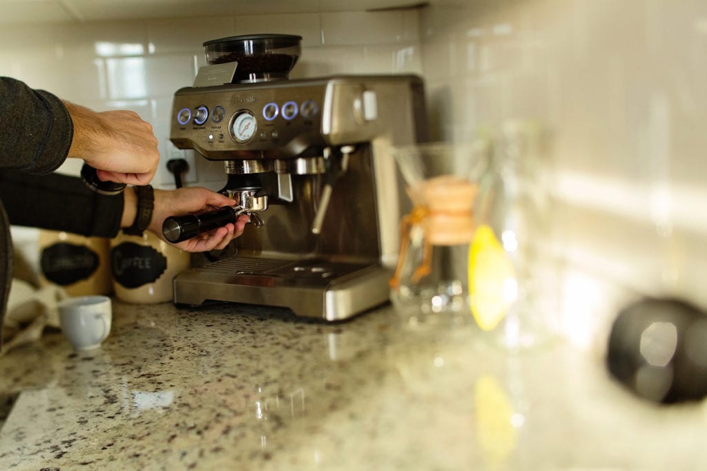 Couple making coffee in urban Cornwall loft apartment