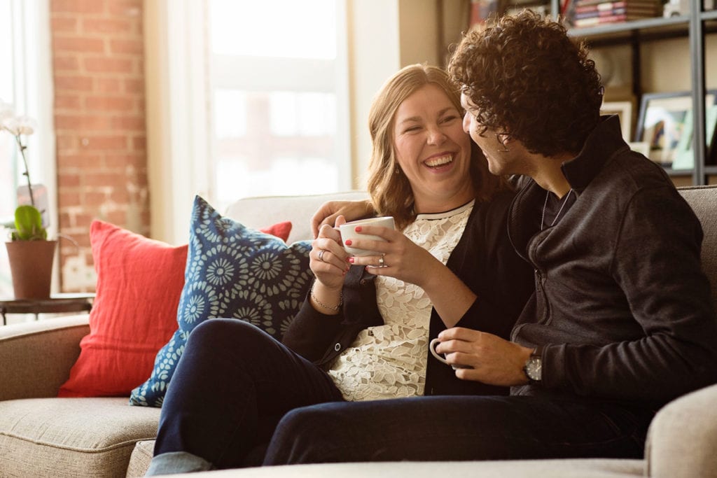 Couple sharing coffee in modern Cornwall loft apartment engagement session