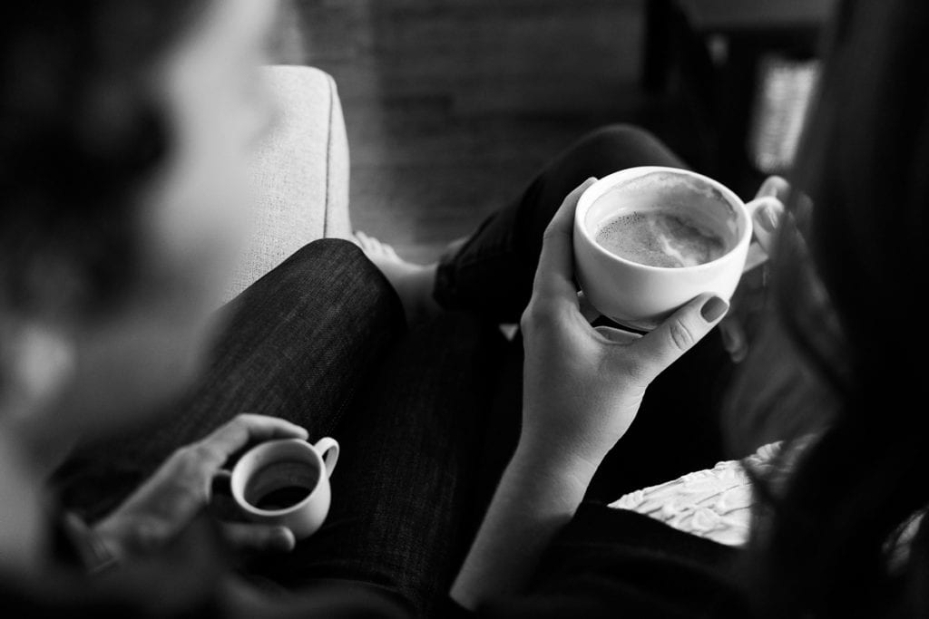 Couple sharing coffee and espresso in modern urban engagement photo