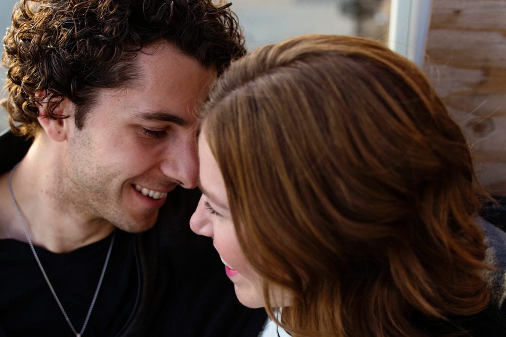 Couple smiling in modern Cornwall engagement shoot