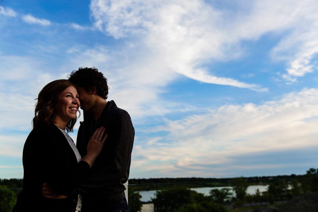 Beautiful couple in rooftop engagement session with river view