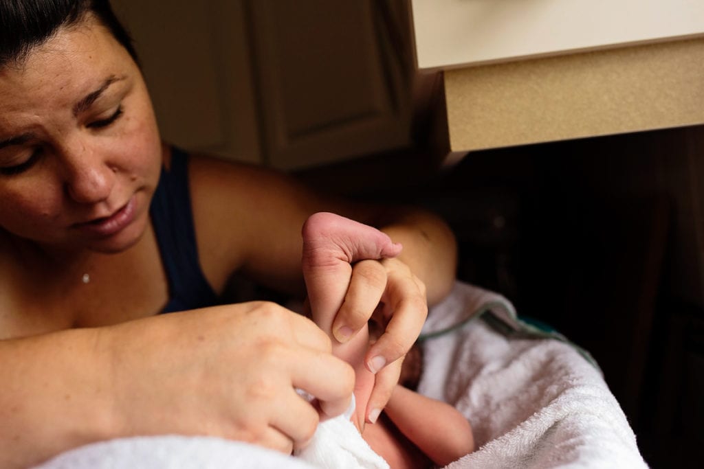 Mom changing newborn baby boy
