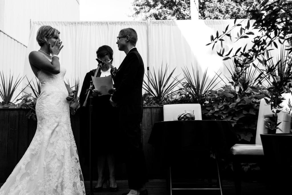 bride wiping away tear during wedding ceremony in chic cornwall wedding
