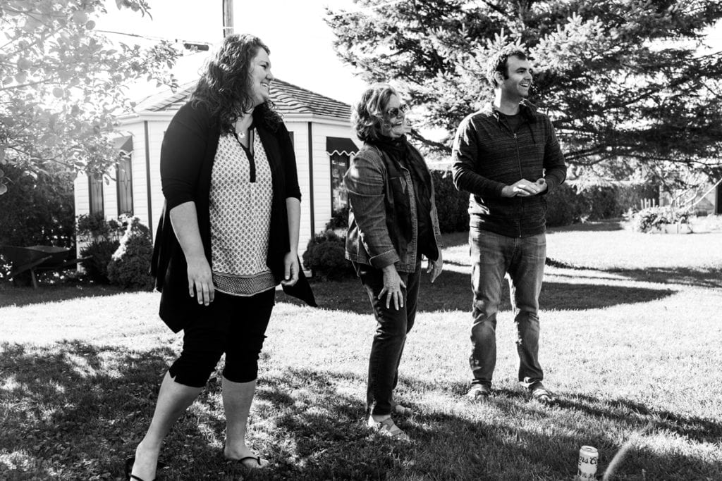mother son and daughter smiling in backyard family photo shoot