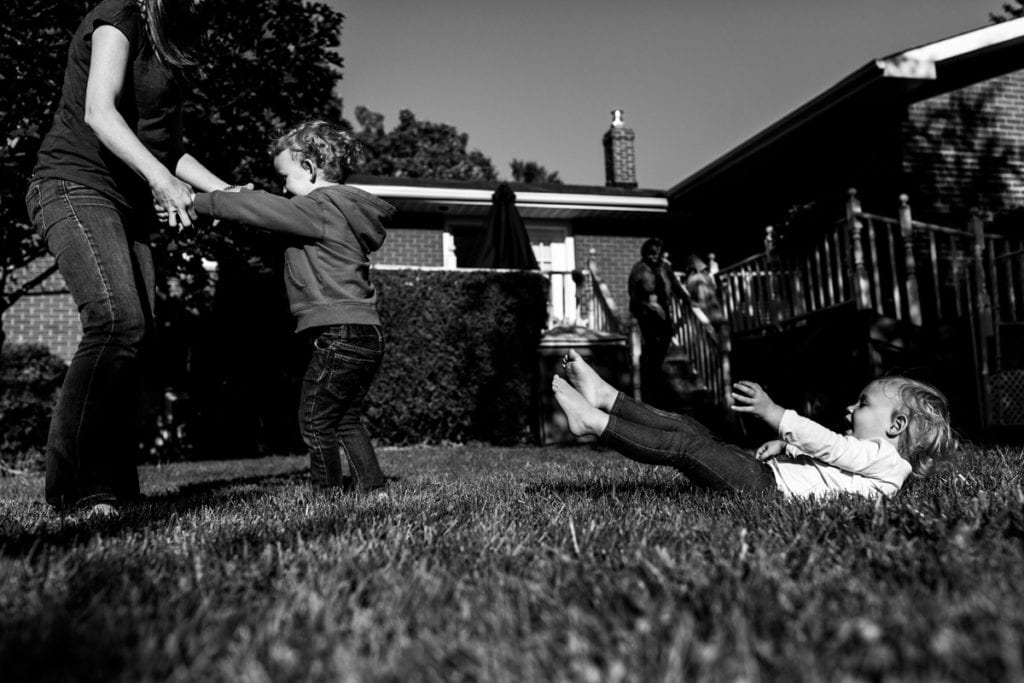 kids rolling and playing in backyard family session