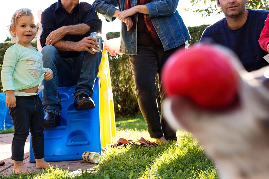 Family playing ball with grandchildren in backyard