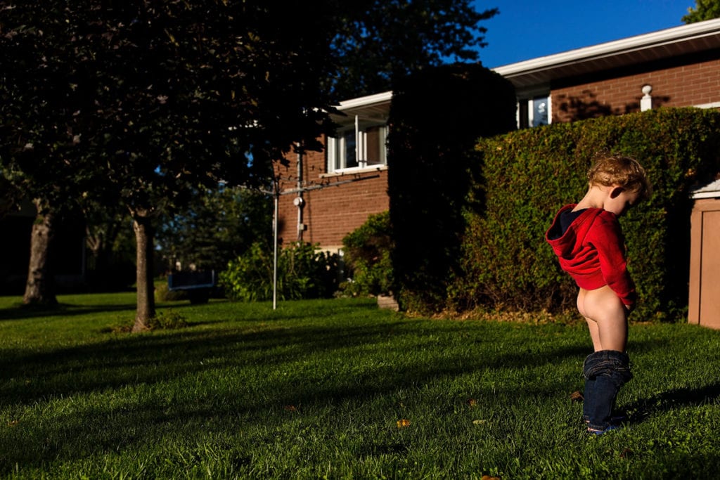 Little boy peeing in candid Cornwall family photos