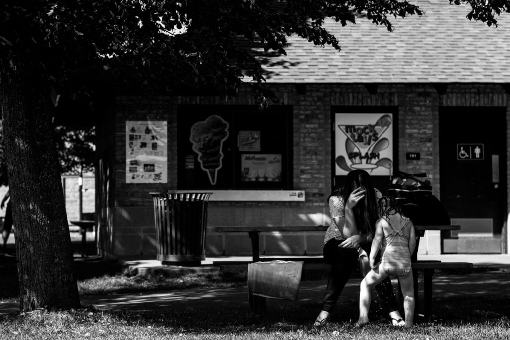 little girl in bathing suit peeing in the park