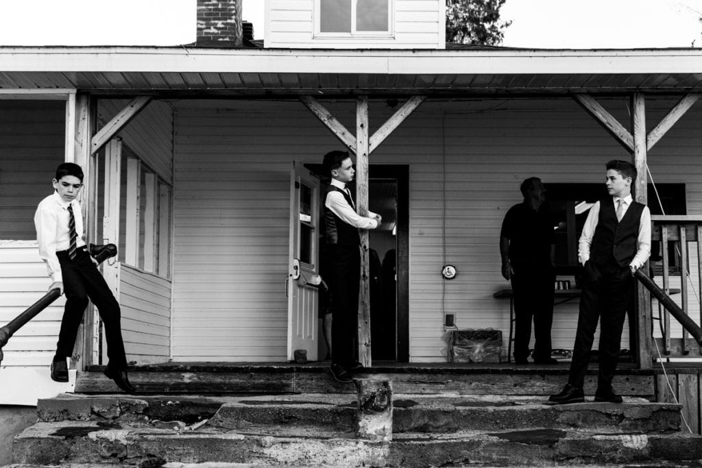 teen boys standing on stairs at entrance to Calabogie wedding reception