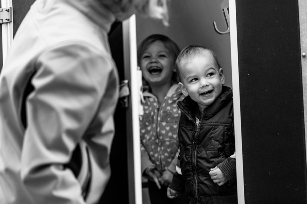little kids playing peekboo and laughing during storytelling photo session