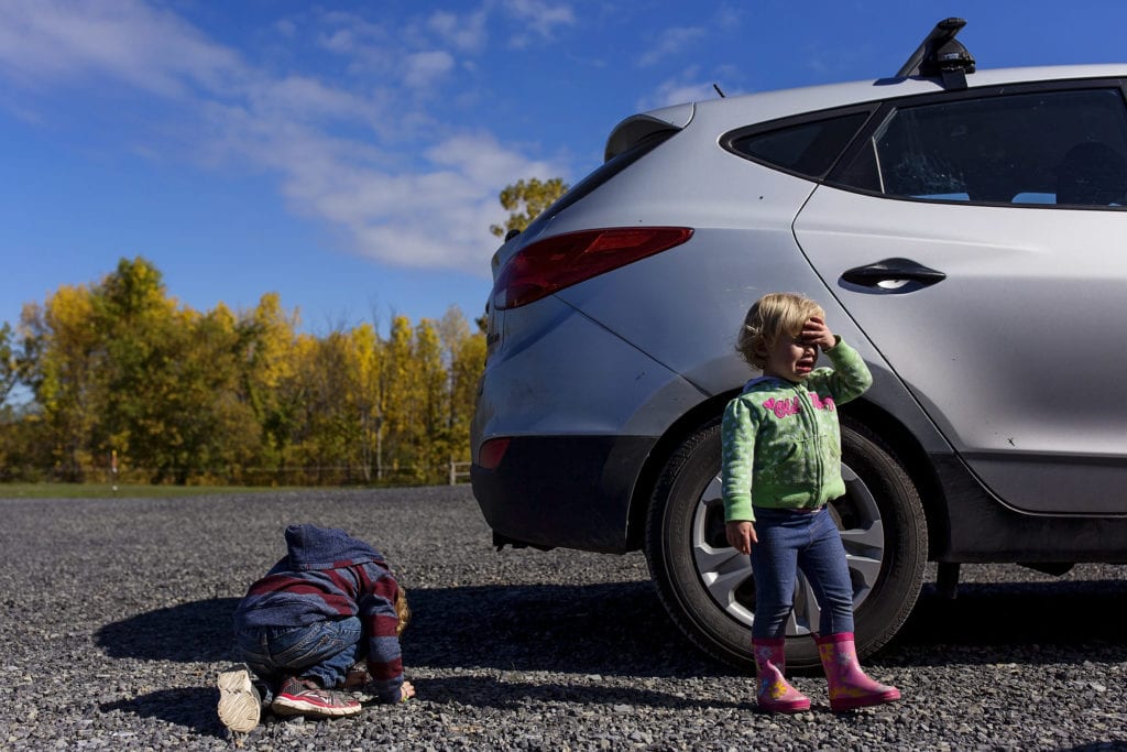 little kids having meltdown in parking lot getting ready to get into car